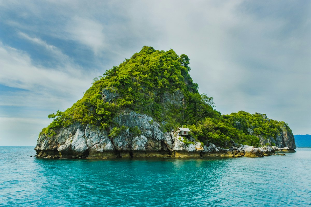 Turquoise Caribbean waters surrounding a pristine tropical island with palm trees in the San Blas Islands Panama