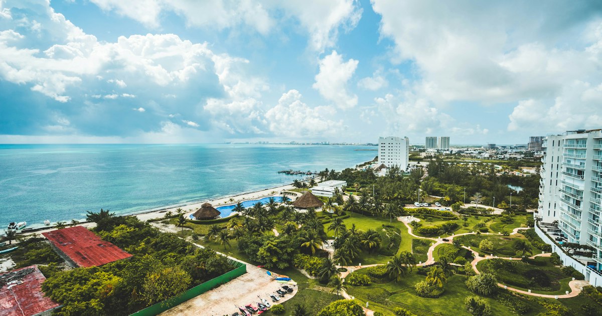 Warm tropical beach with palm trees along the coast